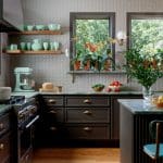 Kitchen with grey penny tile backsplash, dark cabinets, and mint green accents.
