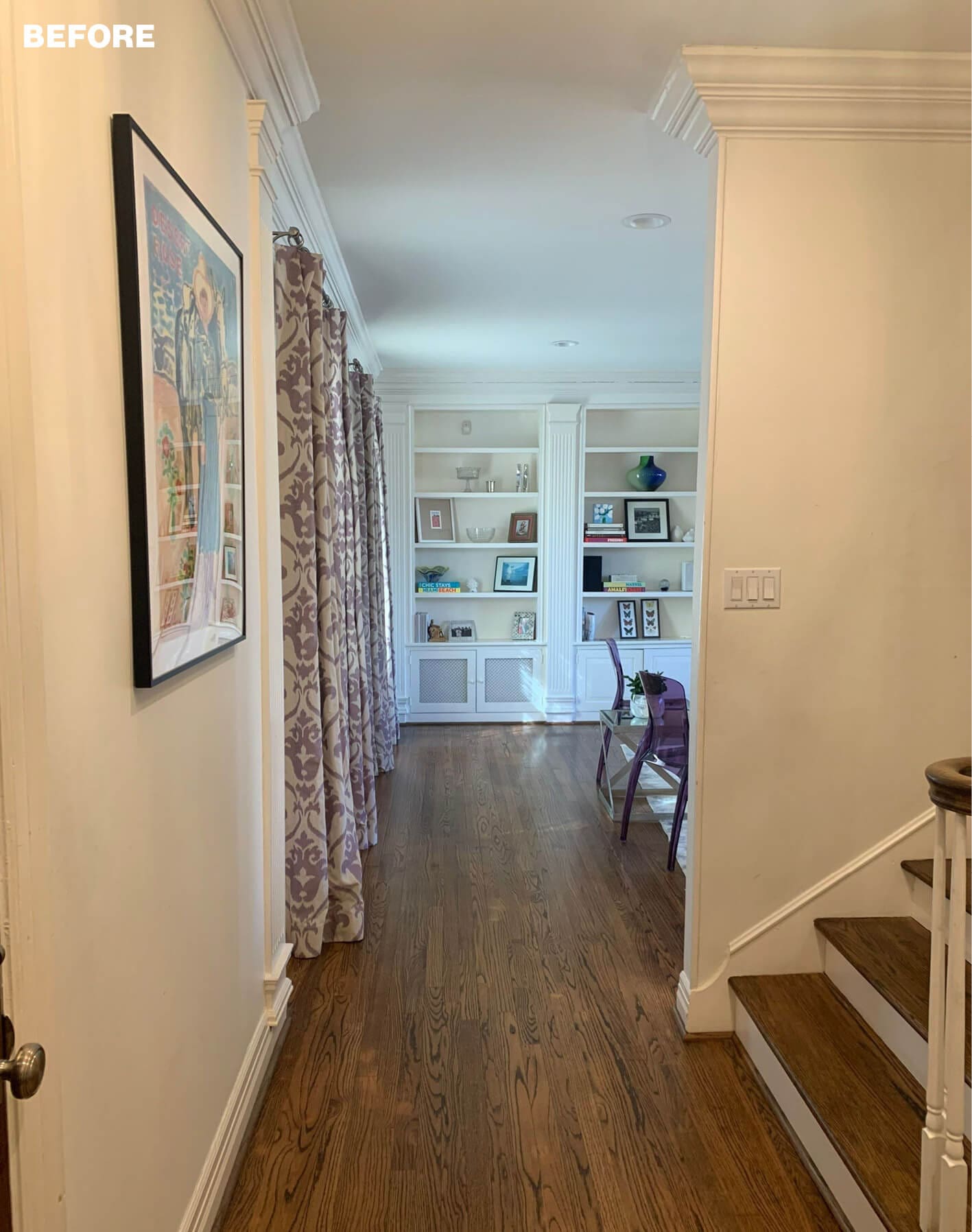 Hallway with dark wood floors, built-in white bookshelves, and purple patterned curtains.