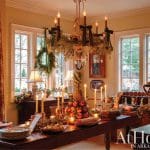Dining room with festive holiday decor, including a pineapple centerpiece and wreaths.
