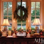 Dining room sideboard with holiday decorations, lamps, and glassware.