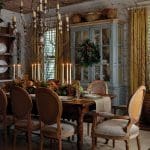 Dining room with ornate chandelier, rustic table set for a meal, and a blue hutch.