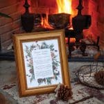 Framed Winter Solstice Fire Ritual instructions next to a fireplace with a basket of pinecones.