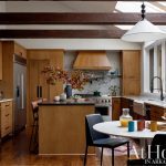 Wood kitchen with marble backsplash, stainless steel appliances, and island.