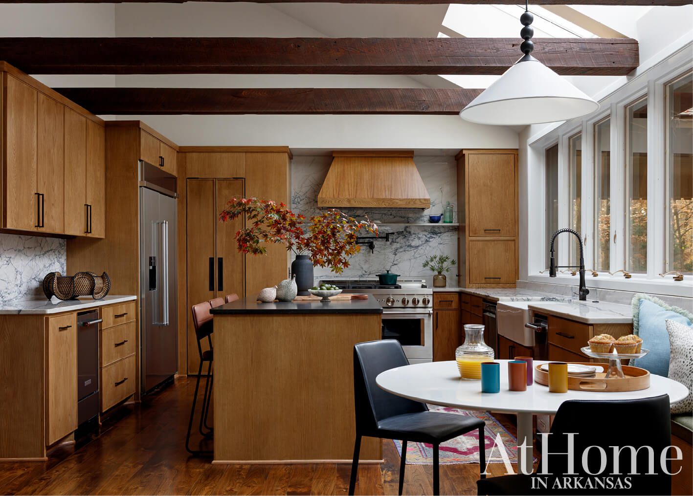 Wood kitchen with marble backsplash, stainless steel appliances, and island.