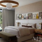 Bedroom with textured headboard, neutral bedding, and large window overlooking trees.