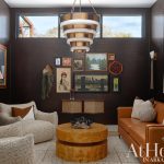 Living room with brown textured walls, leather sofa, boucle chairs, and burl wood coffee table.