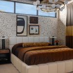 Bedroom with upholstered bed, brown velvet bedding, patterned wallpaper, and modern chandelier.