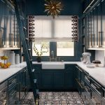 Dark teal kitchen with brass hardware, white marble countertops, and patterned floor