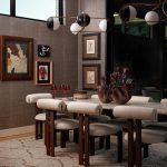 Dining room with textured wallpaper, abstract art, and a modern chandelier over a stone table and