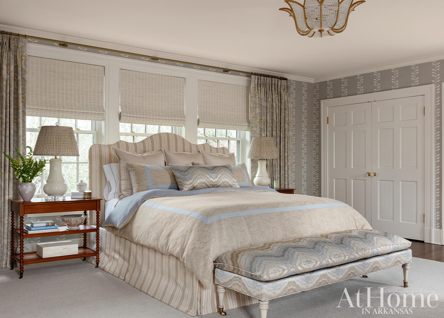 Bedroom with striped headboard, patterned bedding, and floral wallpaper