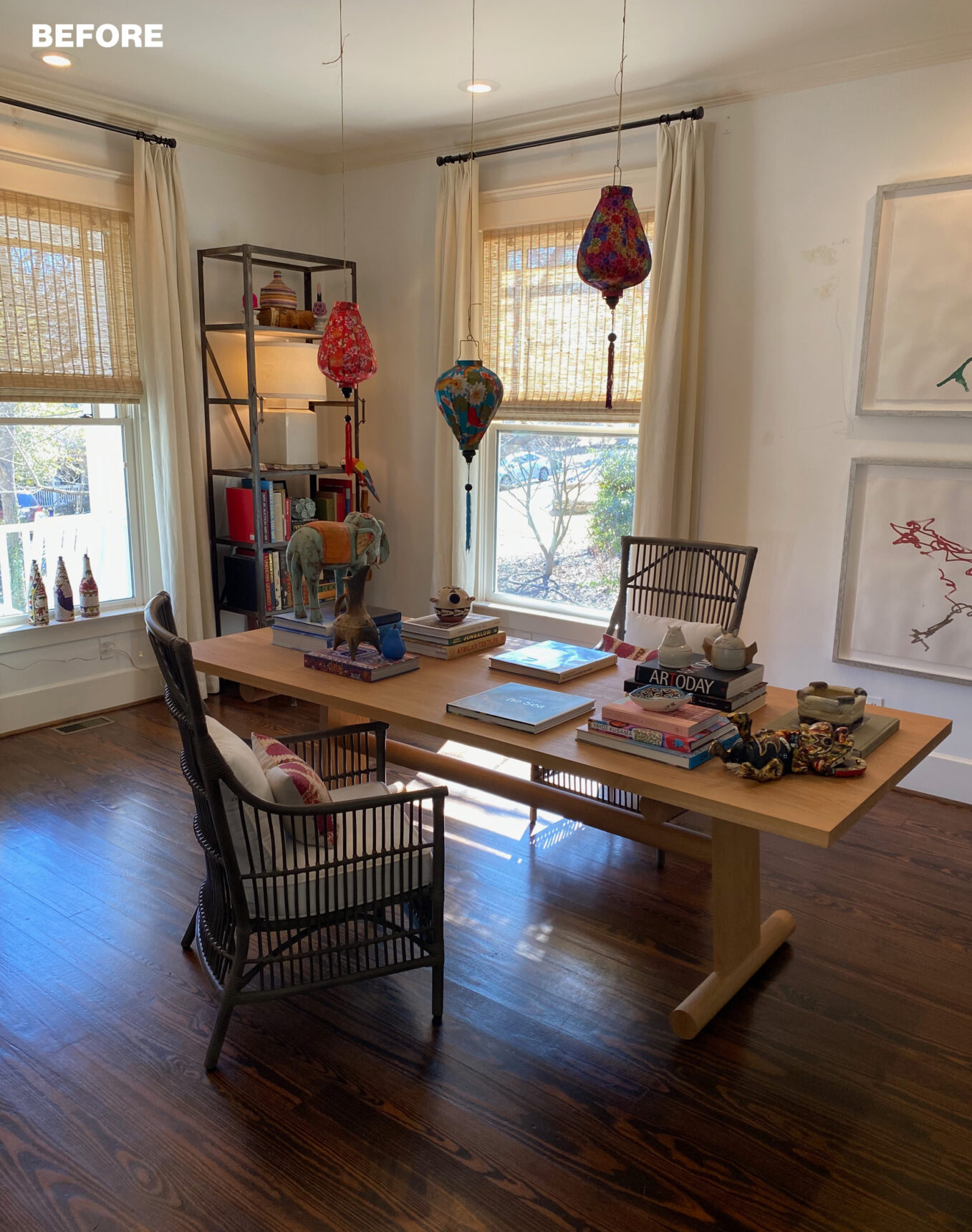 Wooden desk with chairs, books, and decorative items. Hanging lanterns above.