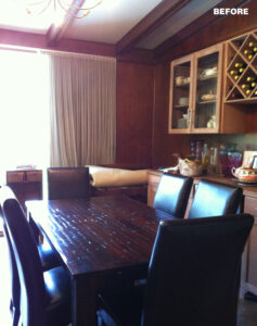 Dining room with dark wood table, black leather chairs, and built-in wine rack.