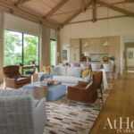 Open-plan living area with wood floors and exposed beams.