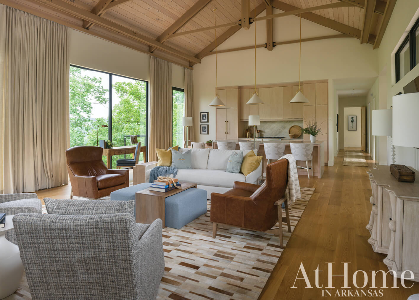 Open-plan living area with wood floors and exposed beams.