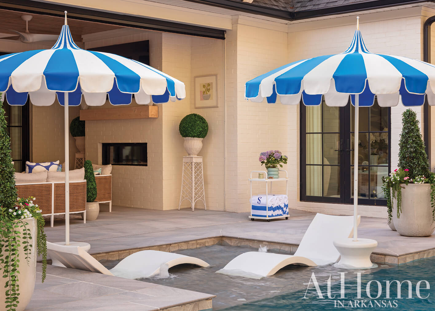 Blue and white striped umbrellas by a pool area.