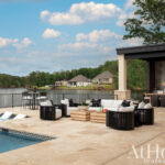 Outdoor patio with pool, seating, and a covered area.