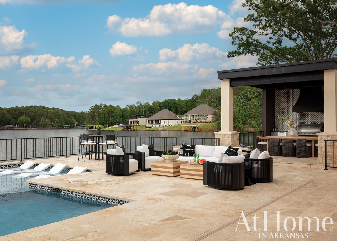 Outdoor patio with pool, seating, and a covered area.