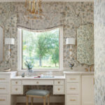 Bathroom with floral wallpaper, window, and vanity.