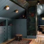 Blue paneled room with painted mural and built-in closet.