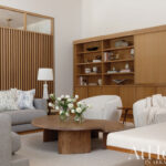 Wooden shelving unit with books and decorative objects.