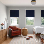 Arlington bedroom with two beds, window treatments, and furniture.