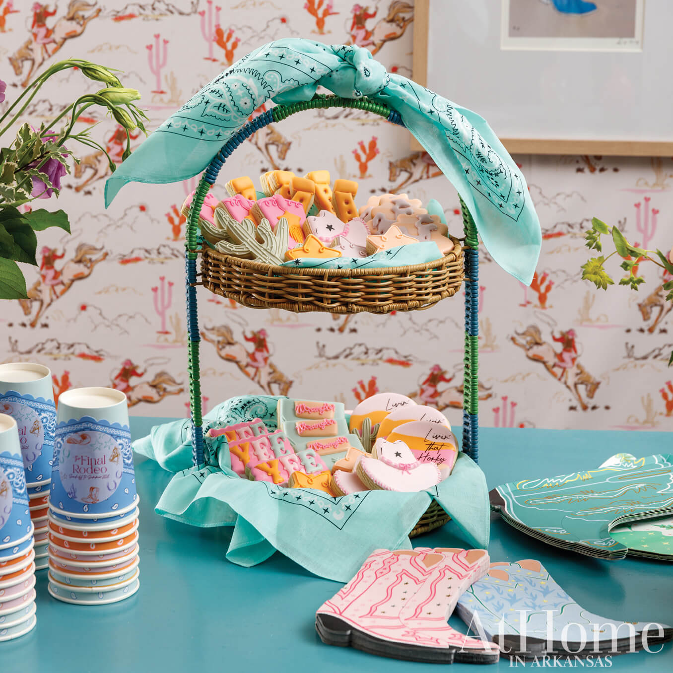 Wicker basket with cookies and a blue bandana on patterned wallpaper.