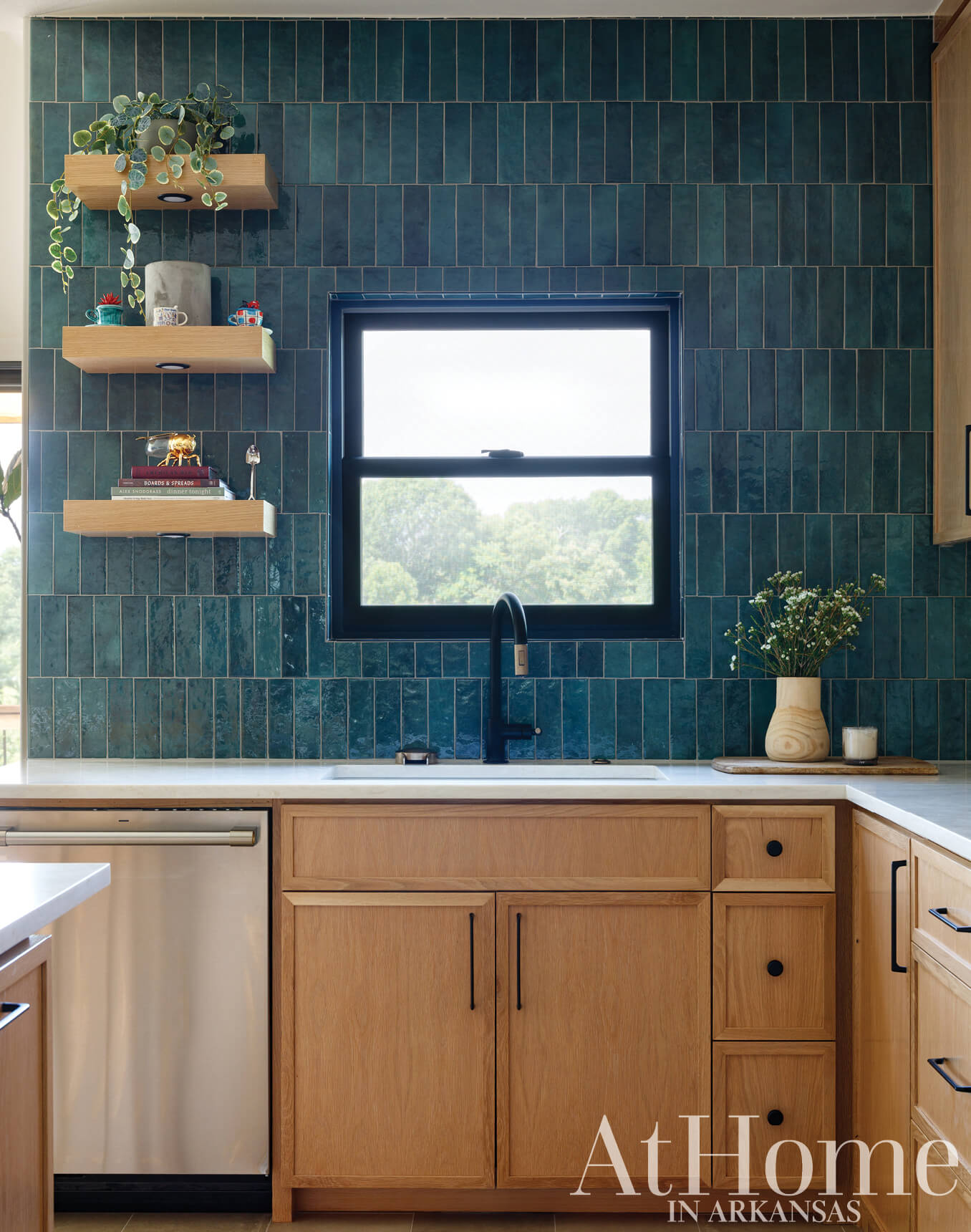 Dark teal tile backsplash with wooden cabinetry and countertop.