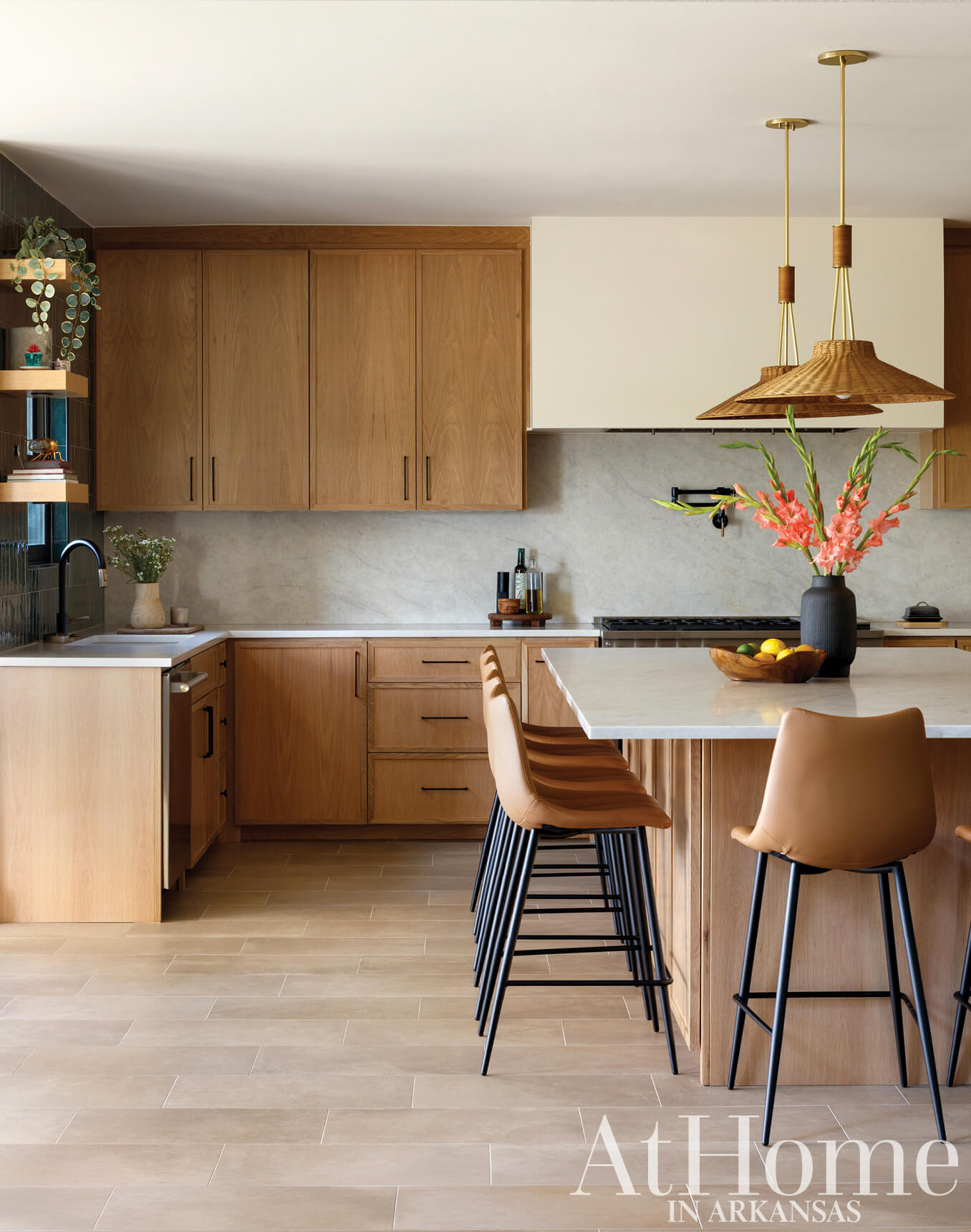 Wooden kitchen cabinets, marble countertop, and pendant lights.
