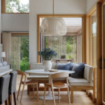 Wooden bench seating with light fixture in a sunlit room.