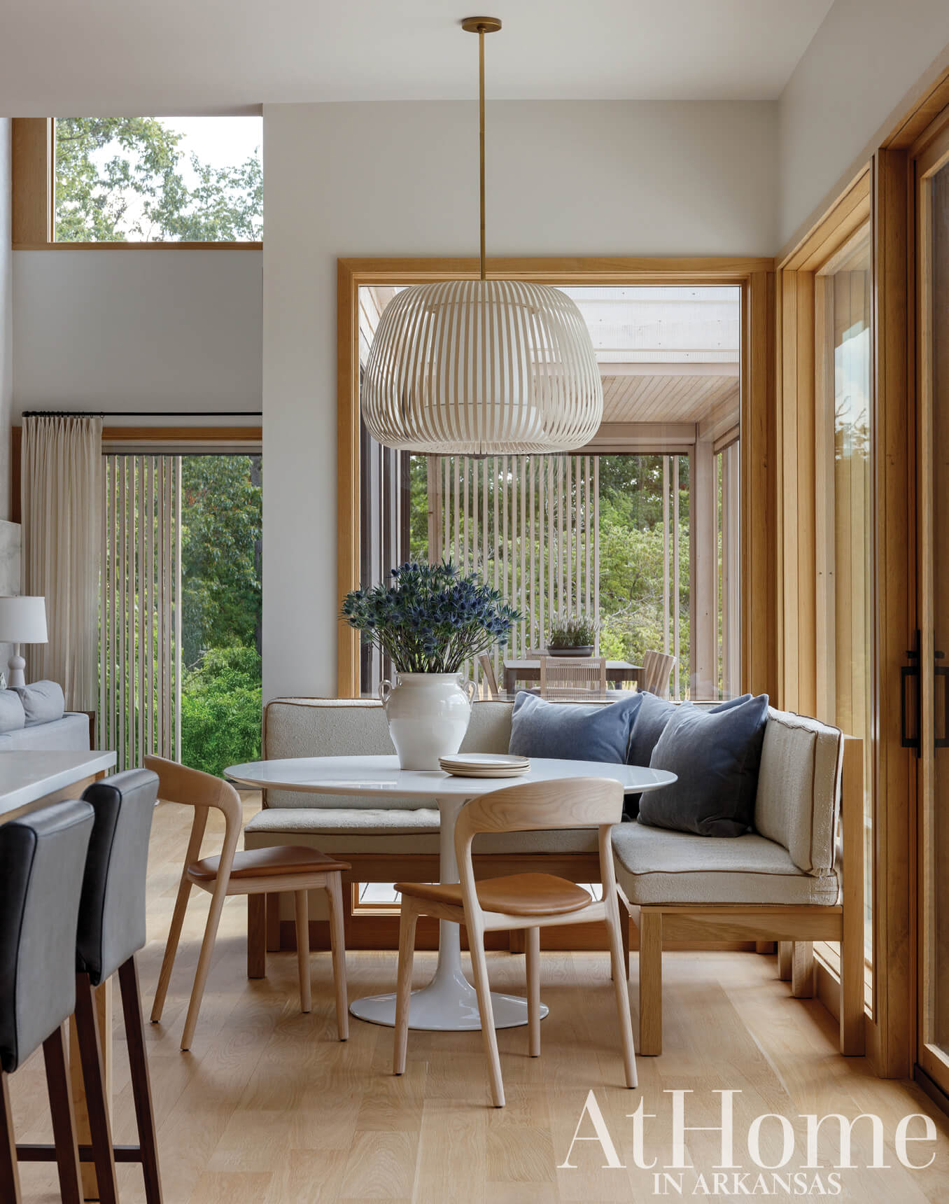 Wooden bench seating with light fixture in a sunlit room.