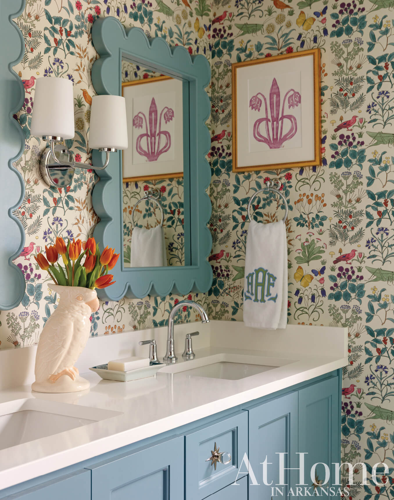 Powder room with teal wallpaper, mirror, and sink.