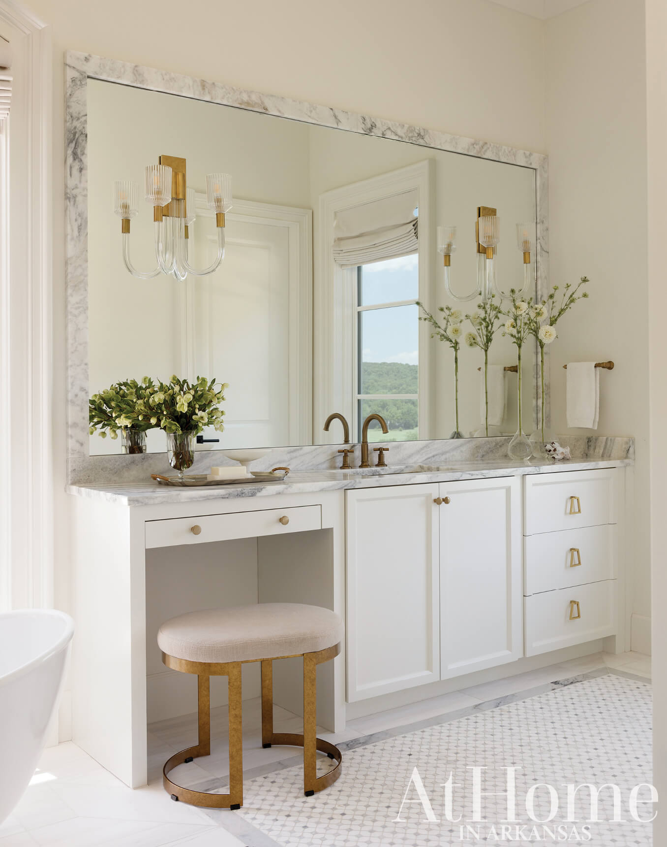 White bathroom vanity with marble countertop and mirror.