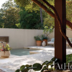 Brick wall with pool, planter, and outdoor seating in Arkansas.