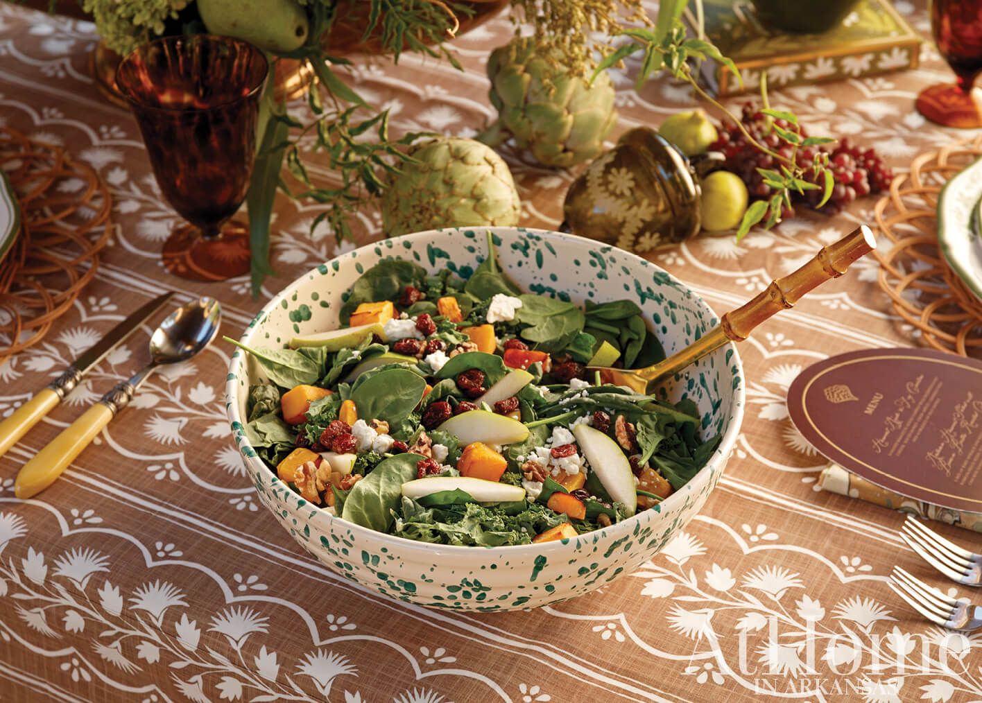 Green and white speckled bowl filled with salad.