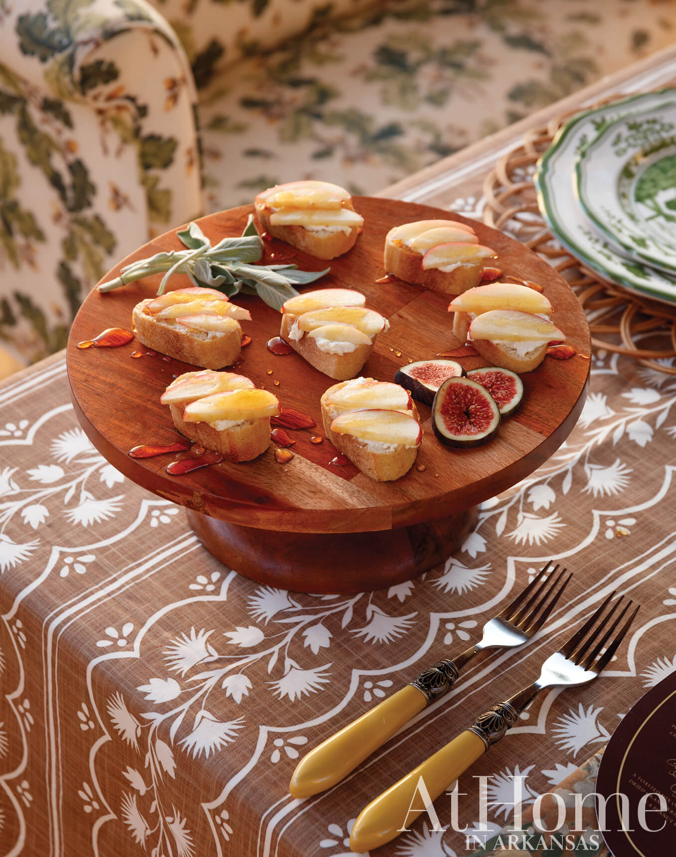 Wooden serving plate with fig and cheese tarts.