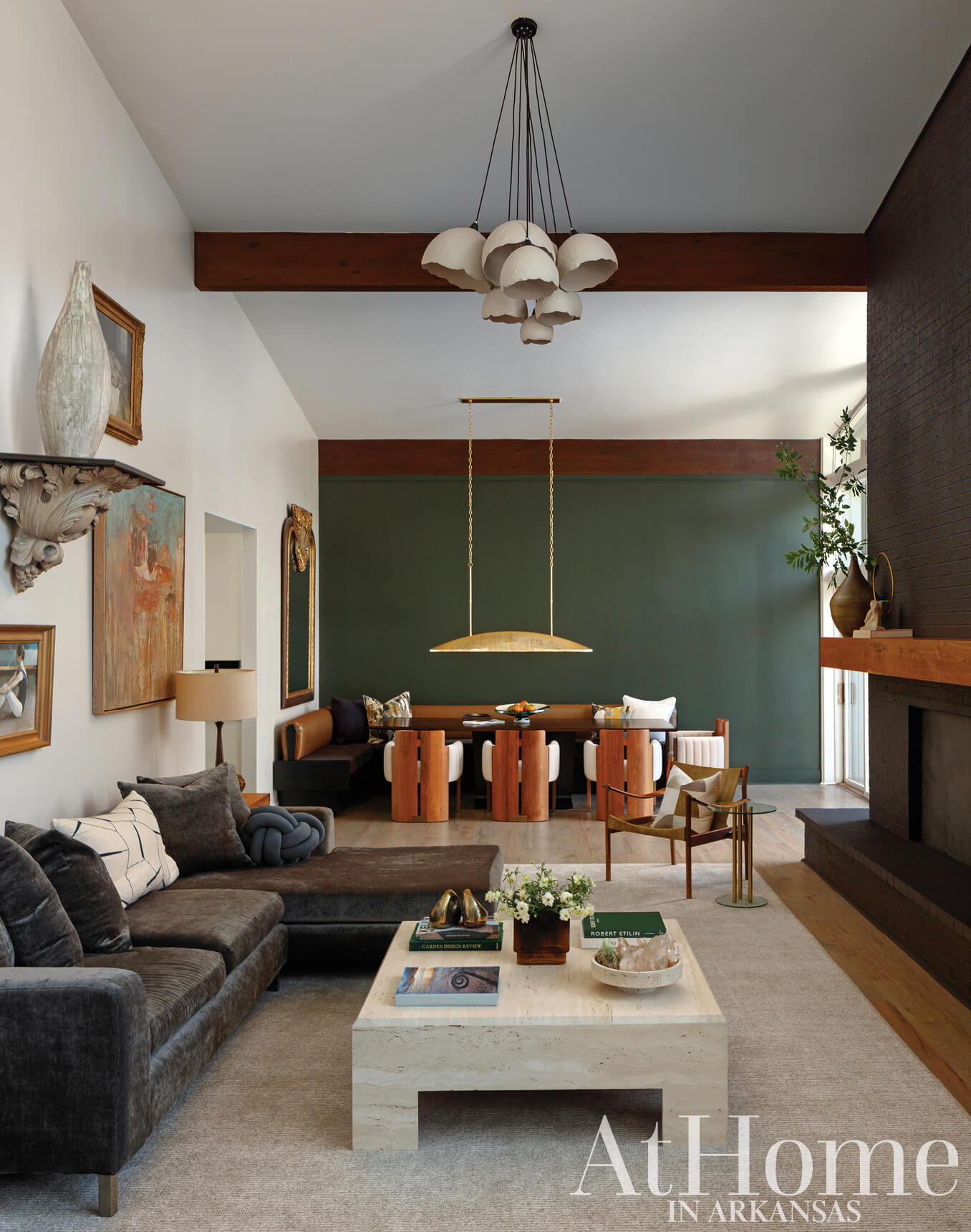 Living room with dark green wall, wooden table, and gray sofa.